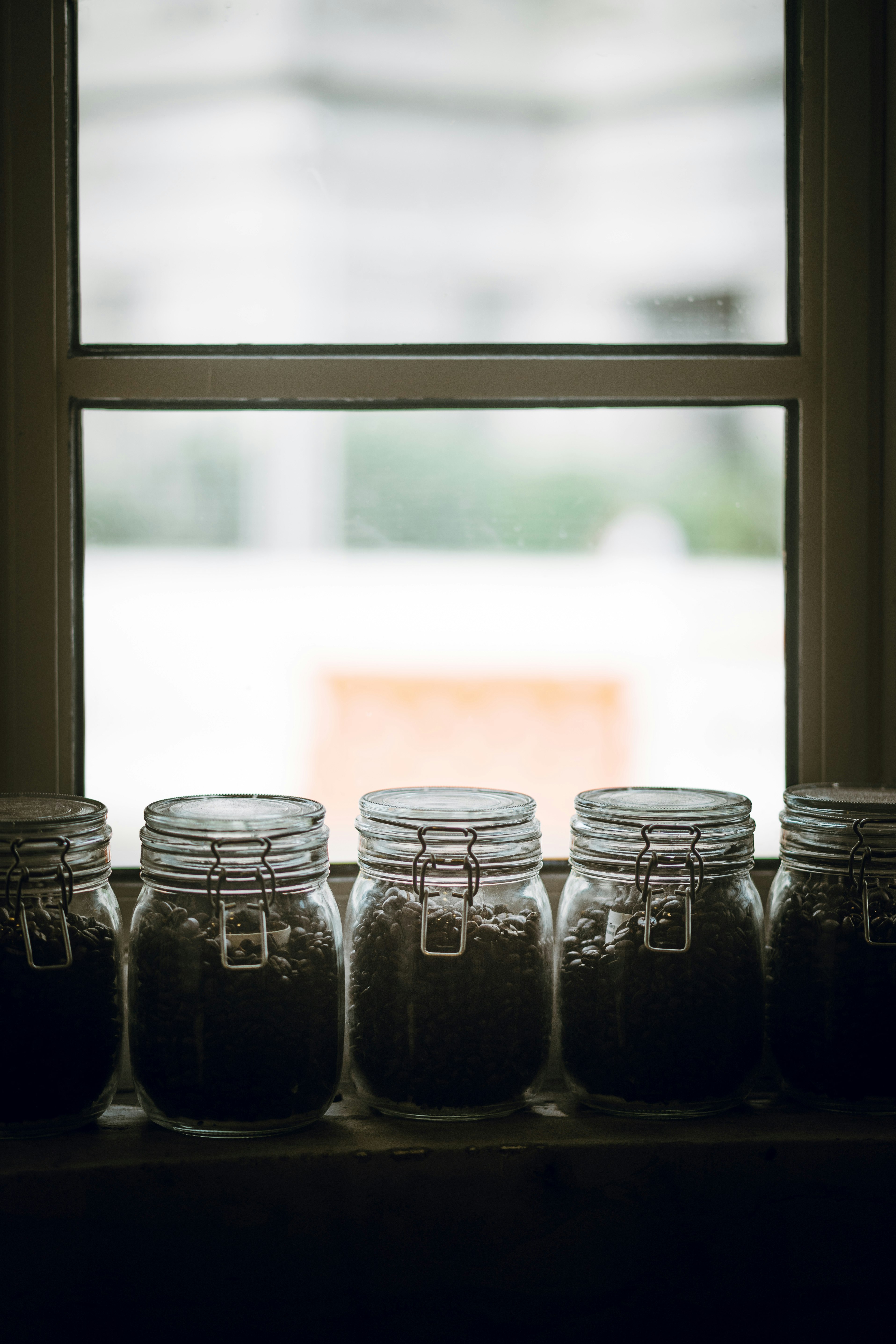 photo of mason jars near at window glass panel frame